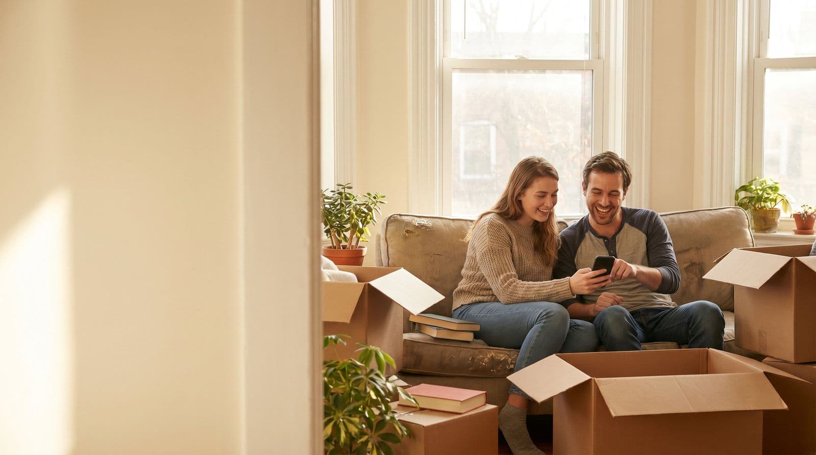 Couple unpacking boxes in their new home